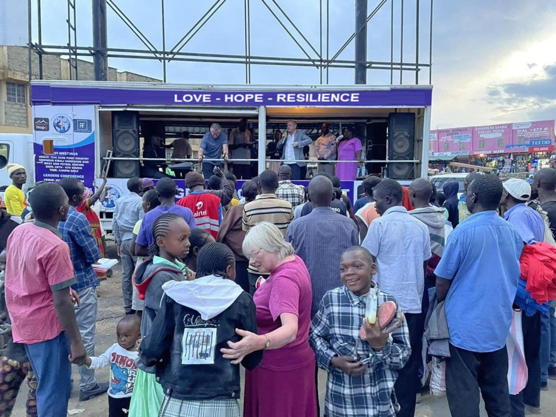 Community outreach under a Love, Hope, Resilience stage