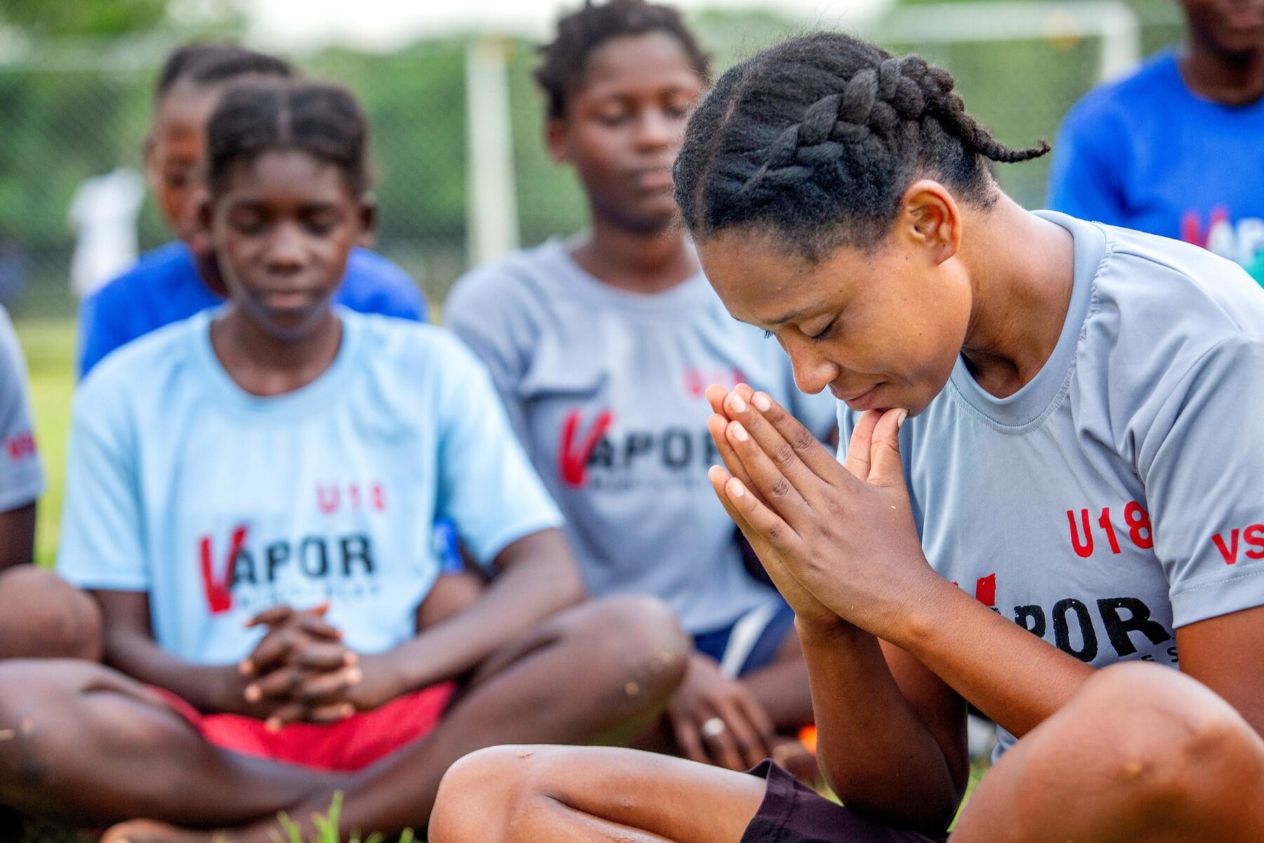 Young people sitting together in prayer