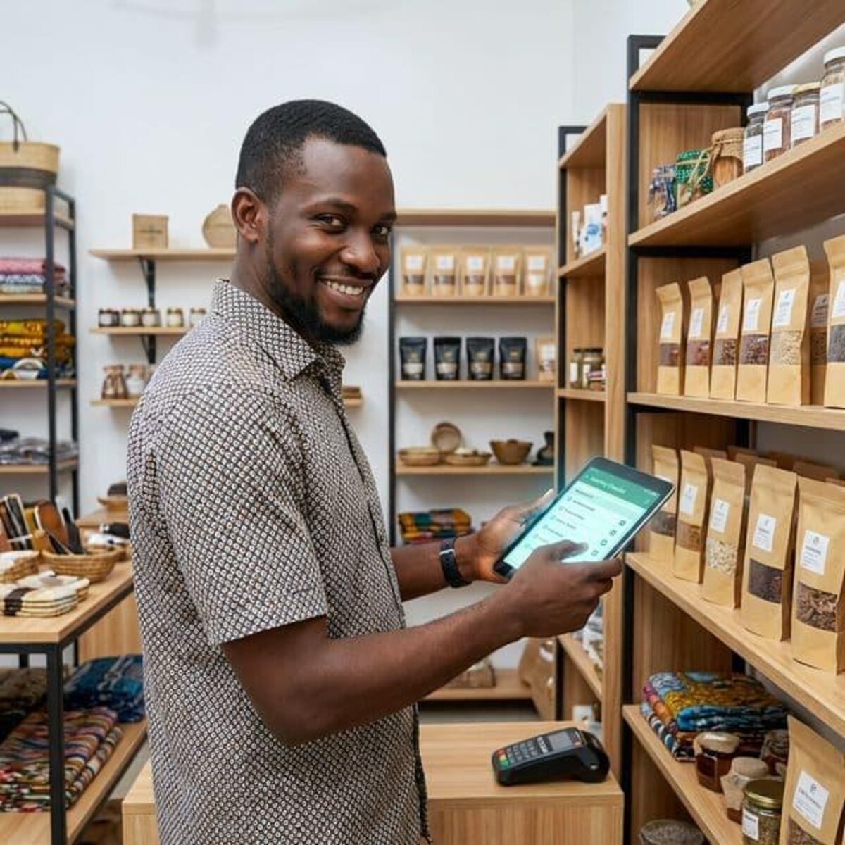 A young shopkeeper using a tablet